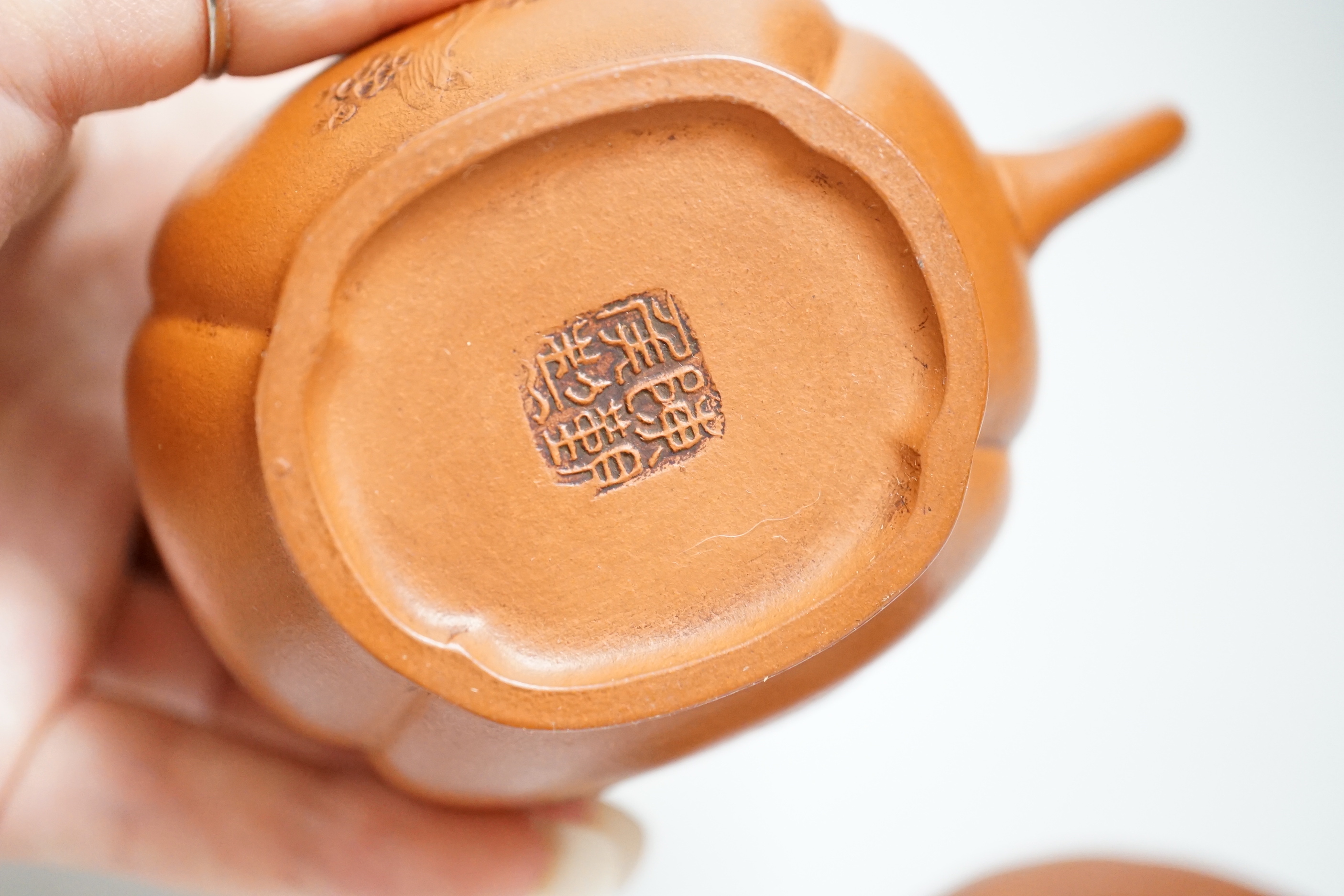 Four Chinese Yixing teapots, one slip decorated with a landscape